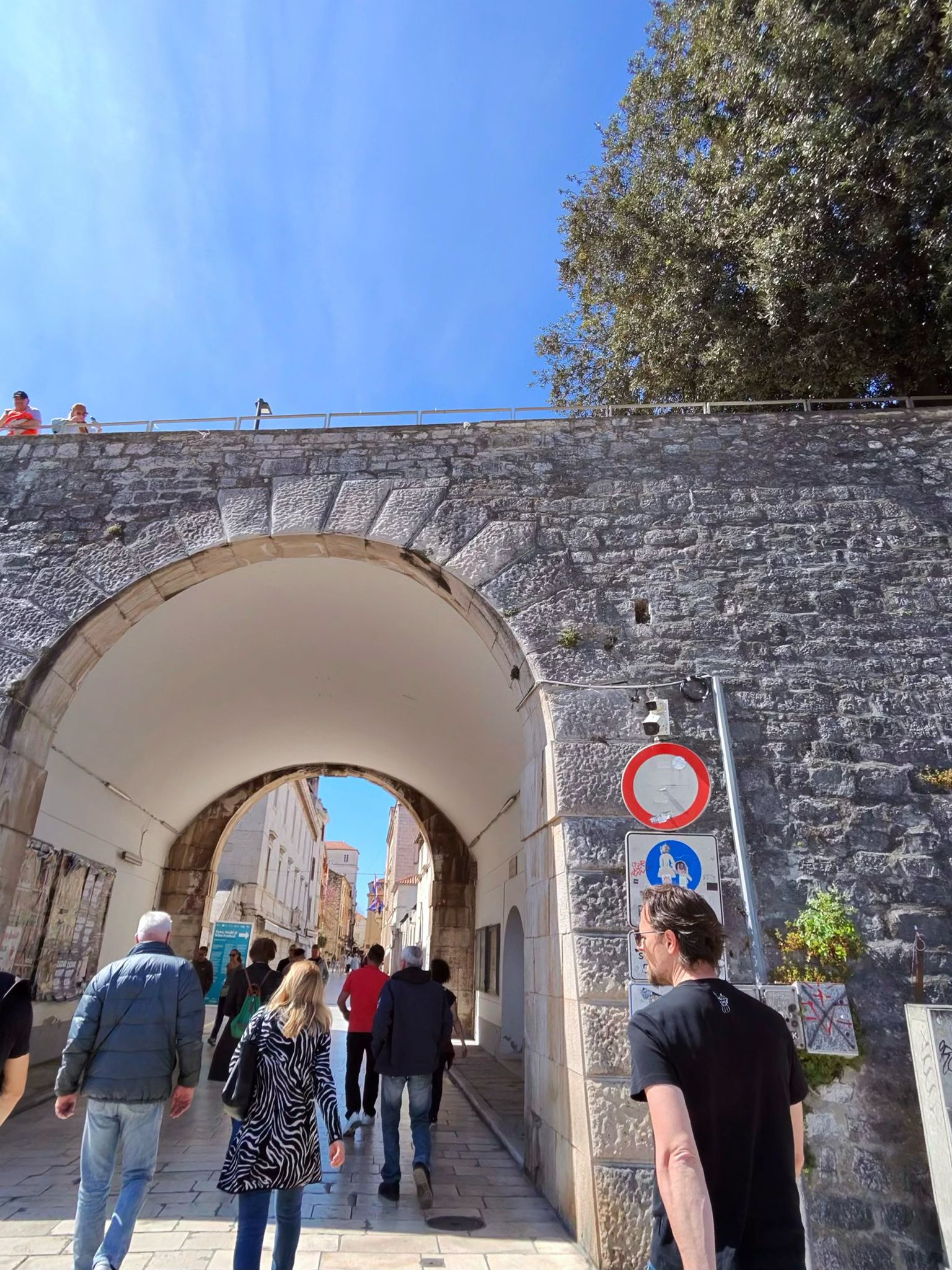 Ancient archway walking tour through Pula old town